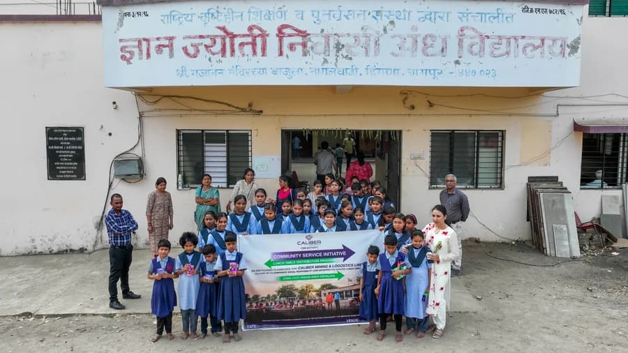 Students holding the Caliber community service banner