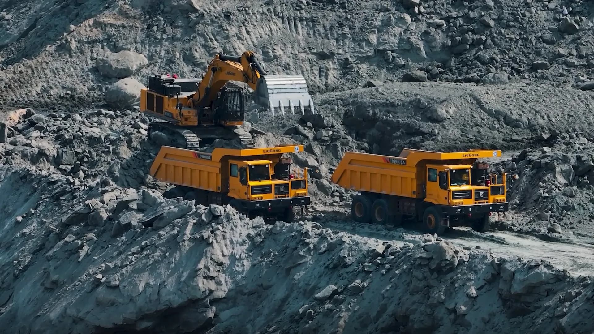A CMLL excavator loading two haul trucks on an open-cast coal bench